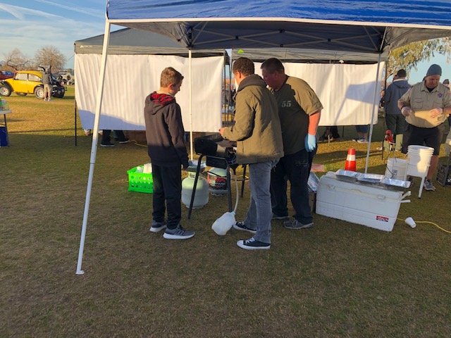 Boy Scouts cooking sausages